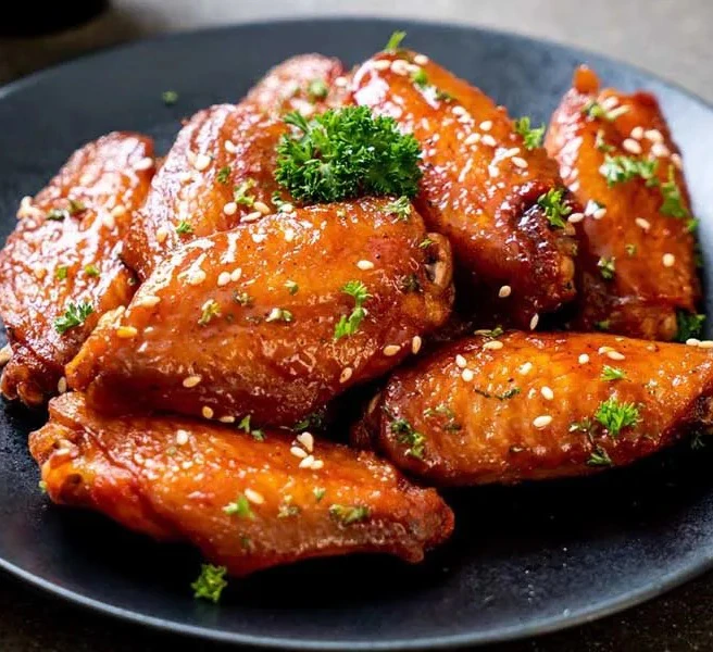 Crispy fried chicken wings glazed in fish sauce with sesame and herbs